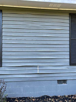 an example of storm damage to siding of a residential home